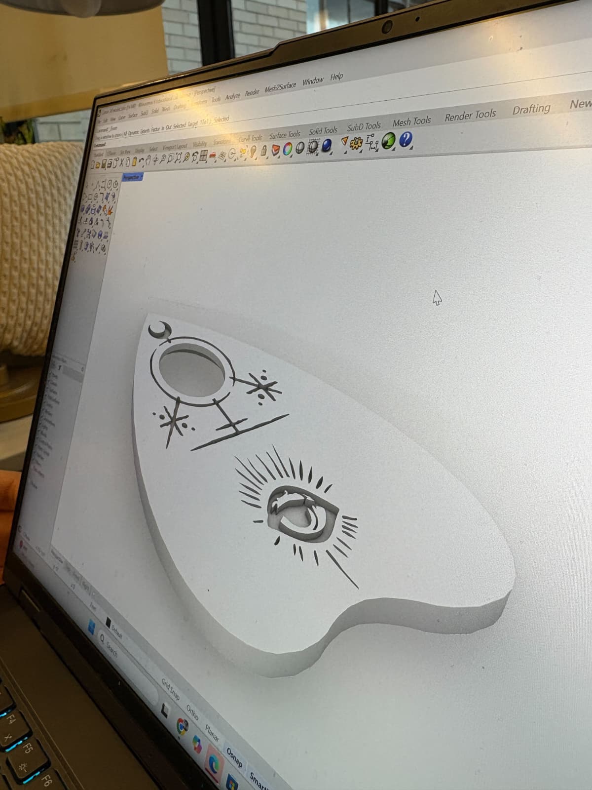 Cursor being painted black on a kraft-paper covered table